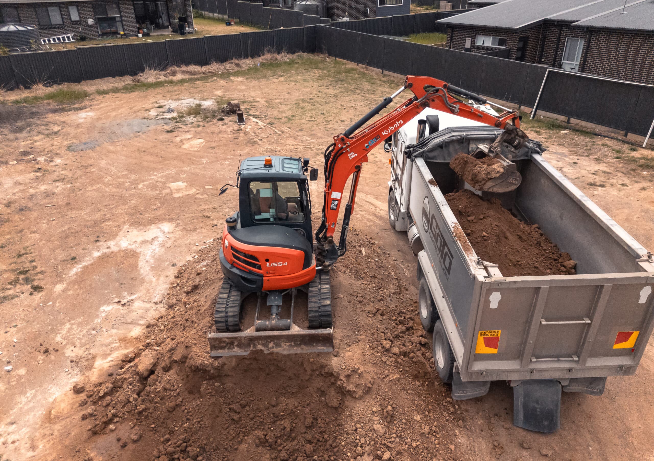 A excavator and dumb trailer loaded a soil